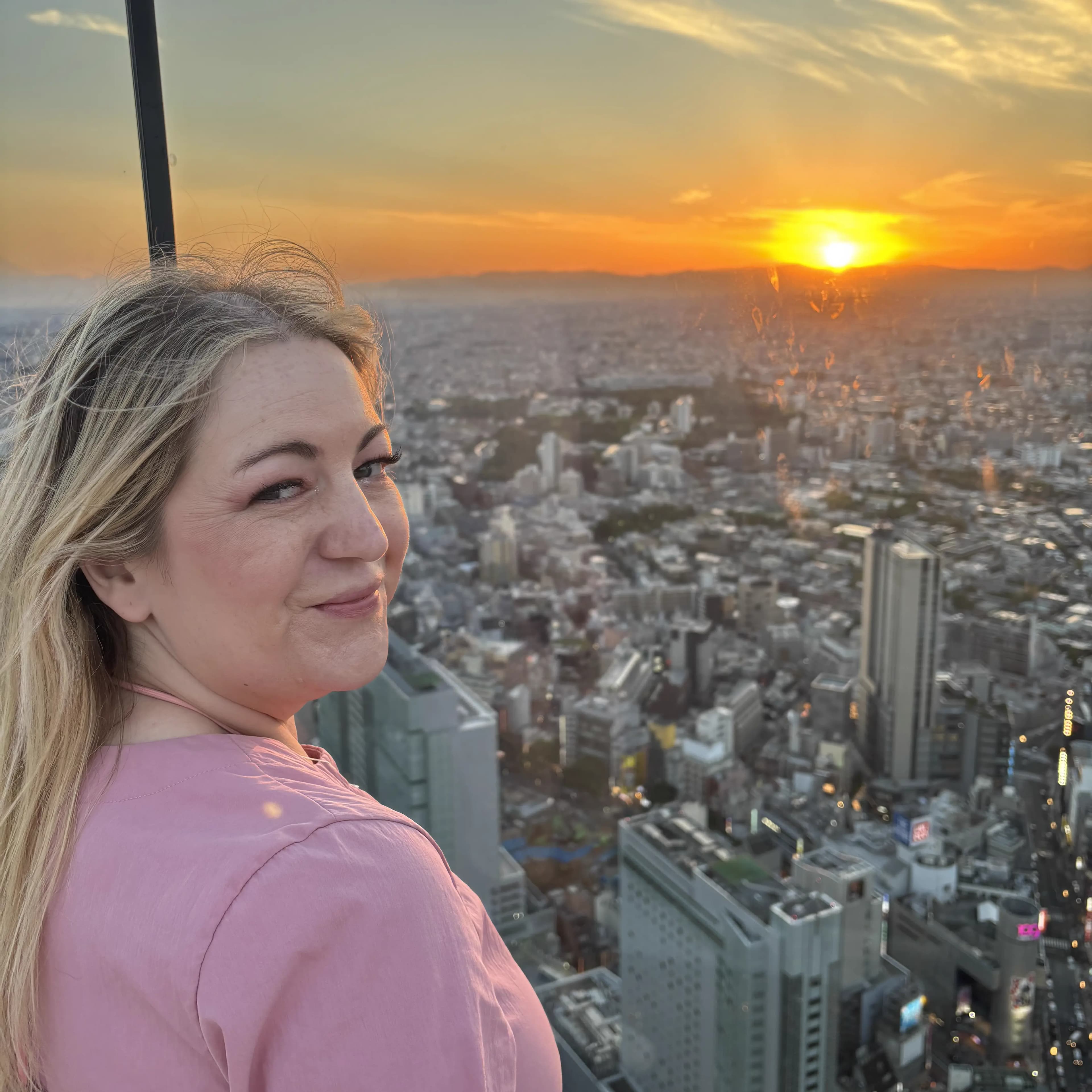 A photo of Jade with a sunset in the background.